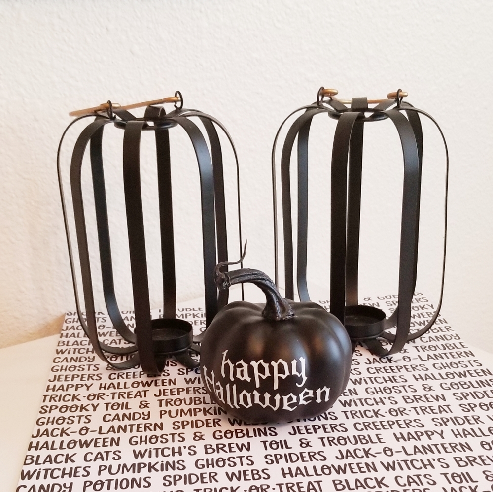 Pair of black metal pumpkin candle holders